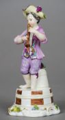 A mid 18th century Meissen porcelain figure of a musician
Modelled standing by a pail of fruit,