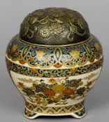 A late 19th century Satsuma jar and cover
The metal cover with floral decoration, the underside