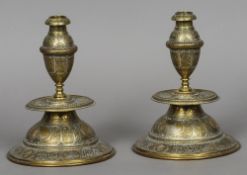 A pair of Continental brass and white metal engraved candlesticks
With central drip-pan and standing