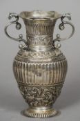 A 19th century Dutch silver vase
With twin scrolling handles with dragons head terminals, the