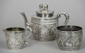 An Indian silver plated three piece tea set
Each piece decorated in the round with various