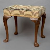 An 18th century style walnut stool
The overstuffed seat above the carved club legs with pad feet.