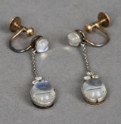 A pair of diamond and moonstone ear pendants
Each set with two cabochon moonstone and three small