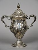 A George III silver trophy cup and cover, hallmarked London 1769, maker's mark of IK
The finial