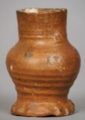 A 16th century European stoneware mug 
The ribbed body with loop handle and pie crust foot.