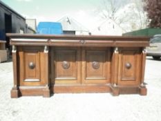 A Victorian Egyptian Revival oak four door sideboard
The rectangular top with three frieze drawers