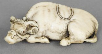 A carved ivory netsuke Formed as an ox, the underside signed. 5.5 cm wide. CONDITION REPORTS: