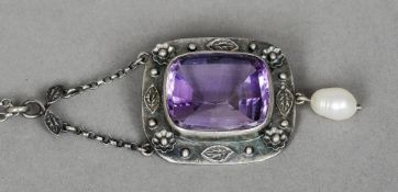 An Arts & Crafts amethyst set white metal pendant 
With floral decorated border and pearl pendant