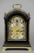A 19th century brass mounted ebonised bracket clock The silvered dial with Roman and Arabic numerals