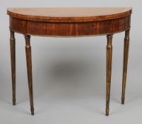 A Georgian satinwood demi-lune card table
Standing on reeded giltwood legs.  81.5 cm wide. CONDITION