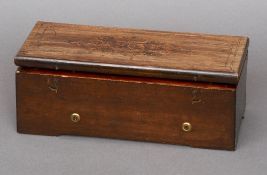 A 19th century Swiss cylinder music box
The marquetry inlaid hinged lid enclosing the brass movement