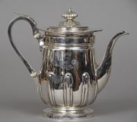 A George IV silver coffee pot, hallmarked London 1820, maker's mark of IET
The front decorated