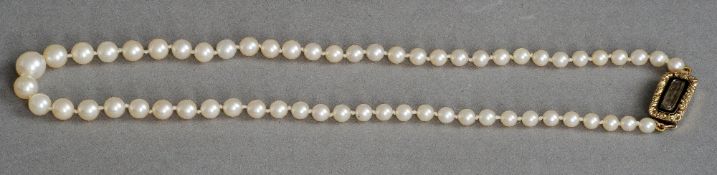 A cultured pearl single-row necklace
Set with an early 19th century unmarked gold and enamel clasp