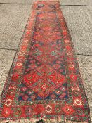 A 19th century Caucasian wool runner
The midnight blue field enclosing seven lozenge medallions