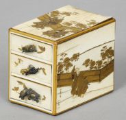 A 19th century Japanese gilt decorated ivory miniature chest of drawers
Decorated with various