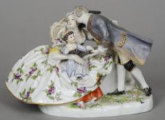 A Continental porcelain group
Modelled as a gentleman embracing his wife, their child upon her