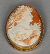 A Victorian 9 ct gold framed cameo brooch
Typically worked with a female bust.  5 cm wide. CONDITION