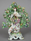 A 19th century porcelain figure Formed as a flower girl before bocage, a lamb at her feet. 24.5 cm