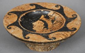 A Roman pottery tazza
Centrally decorated with a figural profile.  19.25 cm diameter. CONDITION
