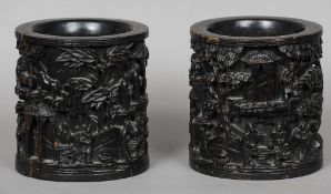 A pair of 19th century Chinese carved hardwood brush pots
Each decorated in the round with various