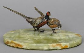 A brace of cold painted bronze model of pheasants
Mounted on an onyx desk stand.  24 cm wide.