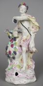 A 19th century English porcelain figure, possibly Bow Formed as a Bacchic figure holding a goblet