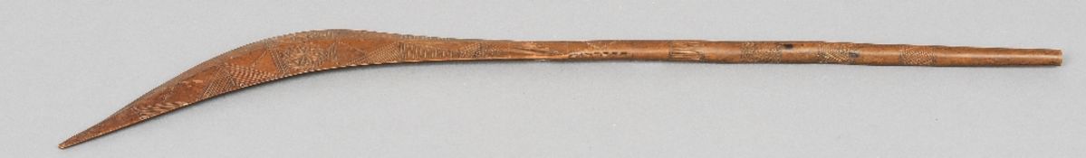 A South Sea Island tribal club
Of slender curved form with chip carved decoration.  86 cm long.