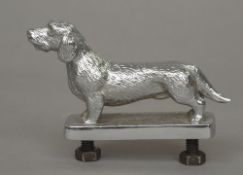 A Louis Lejeune Ltd chromed car mascot
Modelled as a dachshund, stamped mark to base.  10 cm long.