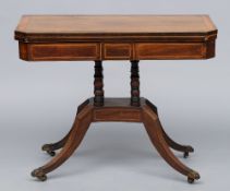 A 19th century mahogany card table
The crossbanded canted rectangular folding top enclosing a