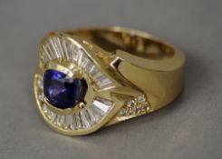 A 14 ct diamond and sapphire ring
The central sapphire bordered by a band of baguette cut diamonds.