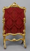 A 19th century gilt framed fire screen
The floral panel in an acanthus and C-scroll frame.  142 cm