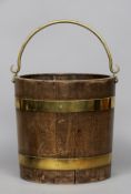 A 19th century brass bound mahogany bucket
With swing handle.  30.5 cm diameter. CONDITION