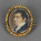 An early 19th century portrait miniature  of a gentleman
Housed in a yellow metal necklace clasp