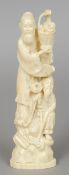 A 19th century Chinese carved ivory group
Worked as two scholars holding flowers, incised