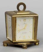 A Hamilton Weathercaster brass cased desk clock
Of rotating square form incorporating timepiece,