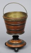 A 19th century Continental walnut and ebonised bucket
With ribbed decoration, swing handle and