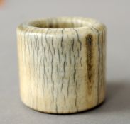 A Chinese ivory archers ring
The plain band of typical form.  2.75 cm high. CONDITION REPORTS: