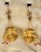 A pair of unmarked gold, seed pearl and cabouchon ruby set ear pendants
Each formed as a dove in a