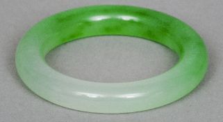 A Chinese carved jade bangle
Light green.  8.5 cm diameter. CONDITION REPORTS: Generally in good