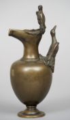 A 19th century patinated bronze ewer
Of plain ovoid form, mounted with birds.  23 cm high. CONDITION