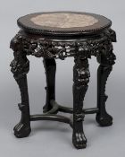 A late 19th/early 20th century marble topped Chinese carved hardwood urn stand
Of lobed circular