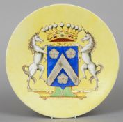 An Italian pottery armorial charger
Decorated on a yellow ground.  38 cm diameter.   CONDITION