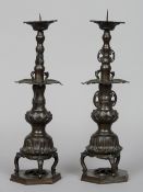 A pair of Chinese bronze altar pricket sticks
With lappet cast drip pans and crane cast collars,