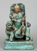 A 17th century Chinese pottery group
Modelled as a deity seated on a kylin,