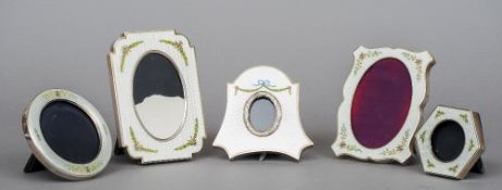 Five enamel decorated silver photograph frames
Of varying shapes and sizes, each with floral