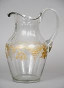 A 19th century etched clear glass ewer
With a loop handle and facet cut neck above the main body