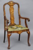 A 19th century Dutch marquetry inlaid open armchair
The shaped top rail above the central back splat