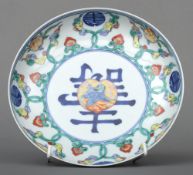 A Chinese porcelain dish
The centre decorated with a crane within a peach vignette, calligraphic