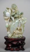 A Chinese carved jade group
Worked as a leaping carp amongst lilies, on carved and pierced wood