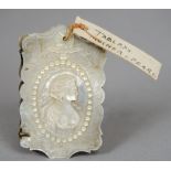A Victorian mother-of-pearl and ivory aide memoire 
The cover well carved with a portrait of a busty